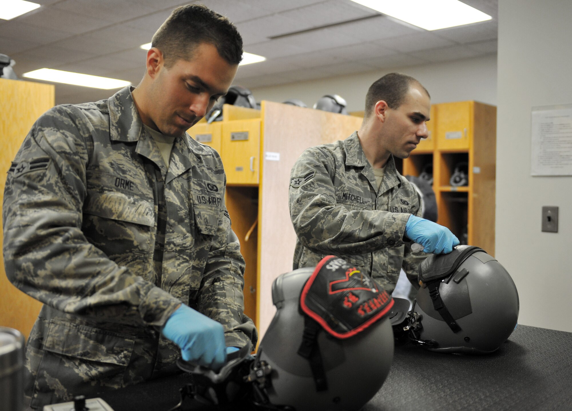 WHITEMAN AIR FORCE BASE, Mo. -- Airman 1st Class Devin Orme and Airman 1st Class Eric Mitchell, 509th Operations Support Squadron aircrew flight equipment journeymen, clean oxygen masks, Jan. 18. Aircrew flight equipment specialists inspect, maintain and adjust life support and survival gear for flight-crew members assigned to Whiteman AFB. (U.S. Air Force photo/Heidi Hunt) (Released)