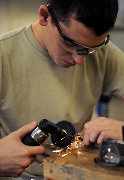 Airman Dylan Fox, 2nd Maintenance Squadron Fabrication Flight sheet metal, uses a grinder to cut sheet metal on Barksdale Air Force Base, La., Jan. 29. The fabrication flight makes metal parts for aircraft and repair aerospace ground equipment. (U.S. Air Force photo/Airman 1st Class Benjamin Gonsier)