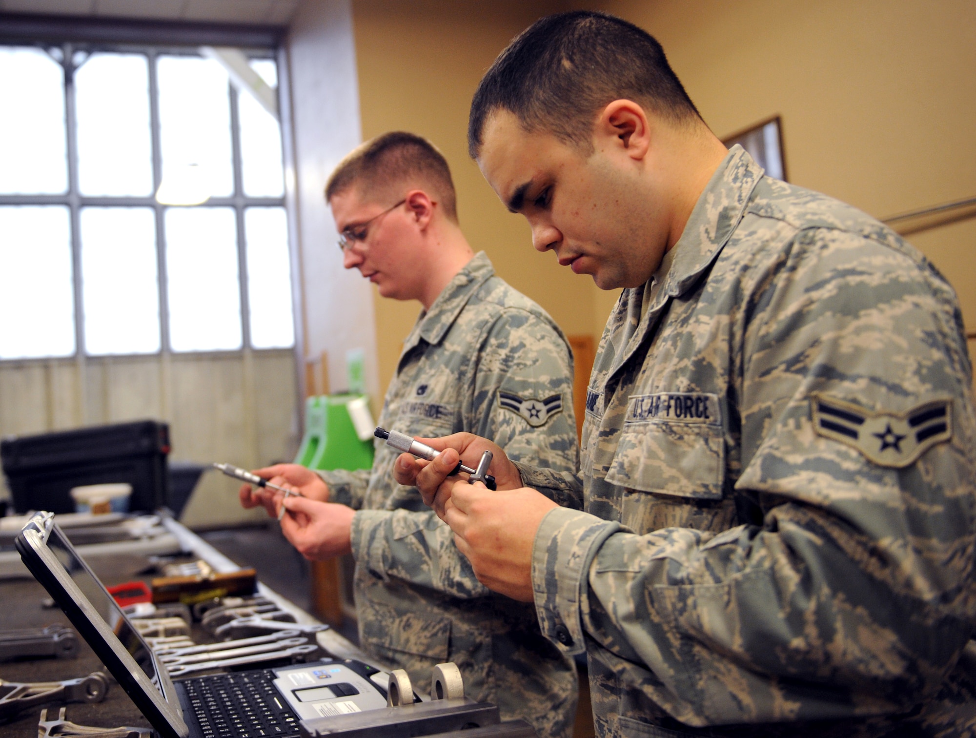 Airmen 1st Class Michael Lane and Nicholas Singleton, 2nd Maintenance Squadron Fabrication Flight metals technology, check engine mounts on Barksdale Air Force Base, La., Jan. 29. Lane and Singleton checked the diameters of the engine mounts to ensure they are correct and within tolerance. If the parts malfunction, the engine will be held improperly. (U.S. Air Force photo/Airman 1st Class Benjamin Gonsier)
