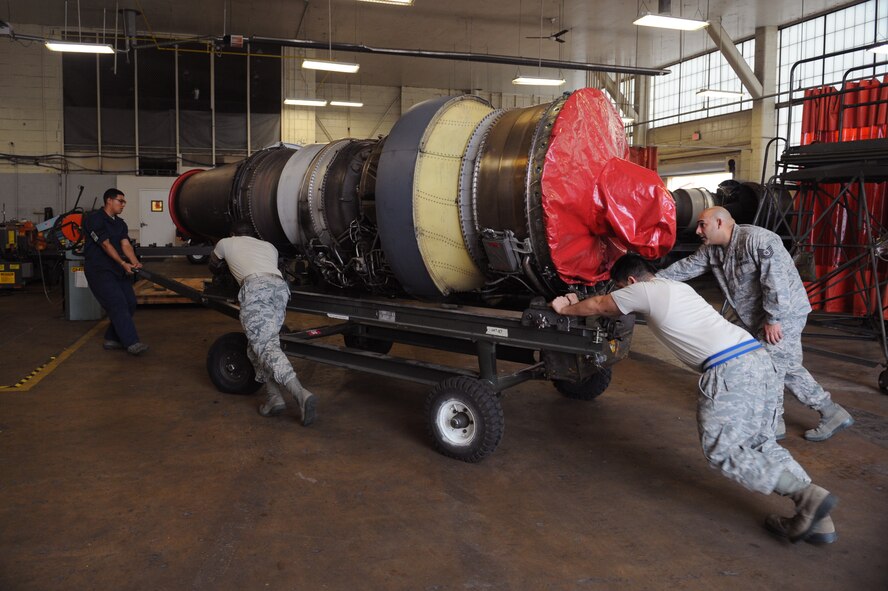 Airmen from the 2nd Maintenance Squadron Fabrication Flight move a B-52H Stratofortress engine on Barksdale Air Force Base, La., Jan. 29. The fabrication flight makes metal parts for aircraft and repair aerospace ground equipment. (U.S. Air Force photo/Airman 1st Class Benjamin Gonsier)