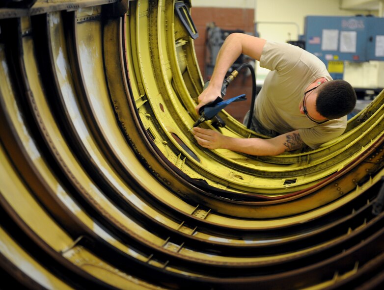 Senior Airman Dillon Dunbar, 2nd Maintenance Squadron Fabrication Flight sheet metal, drills rivets out of a lower body cowling on Barksdale Air Force Base, La., Jan. 29. Airmen from the fabrication flight repair or replace sheet metal and fix loose rivets and cracks on the B-52H Stratofortress. (U.S. Air Force photo/Airman 1st Class Benjamin Gonsier)