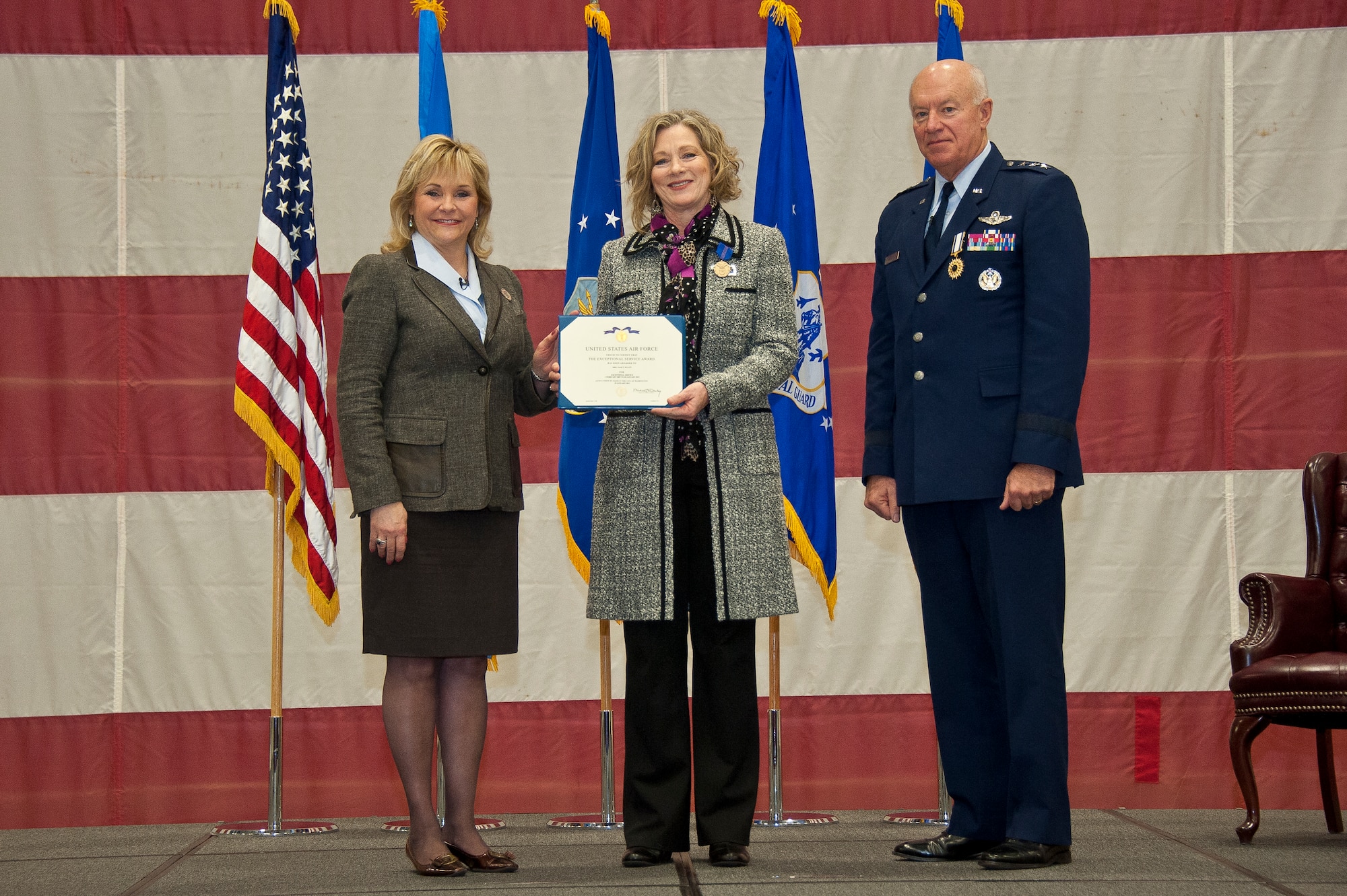 Oklahoma Gov. Mary Fallin presents Nancy Wyatt, wife of Air Force Lt. Gen. Harry M. Wyatt III, the director of the Air National Guard, an Exceptoinal Service Award during Gen. Wyatt’s retirement ceremony Jan. 29, 2013, at Joint Base Andrews, Md. Wyatt retired after more than 40 years of military service culminating as the Director of the ANG where he was responsible for formulating, developing and coordinating all policies, plans, and programs affecting more than 106,700 ANG members in 89 wings and more than 200 geographically separated units throughout the United States, the District of Columbia, Puerto Rico, Guam and the Virgin Islands. (National Guard photo by Master Sgt. Marvin Preston/RELEASED)