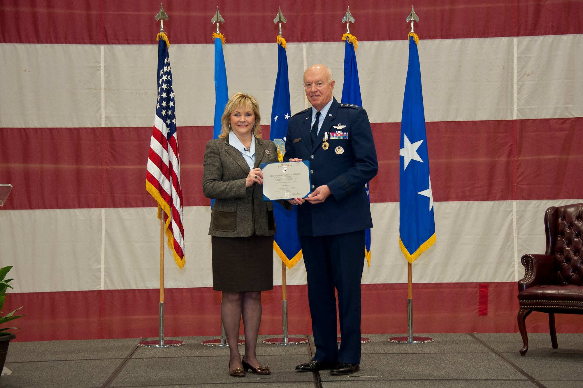 Oklahoma Gov. Mary Fallin presents Air Force Lt. Gen. Harry M. Wyatt III, the director of the Air National Guard, a Distinguished Service Medal during Wyatt’s retirement ceremony Jan. 29, 2013, at Joint Base Andrews, Md. Wyatt retired after more than 40 years of military service culminating as the Director of the ANG where he was responsible for formulating, developing and coordinating all policies, plans, and programs affecting more than 106,700 ANG members in 89 wings and more than 200 geographically separated units throughout the United States, the District of Columbia, Puerto Rico, Guam and the Virgin Islands. (National Guard photo by Master Sgt. Marvin Preston/RELEASED)