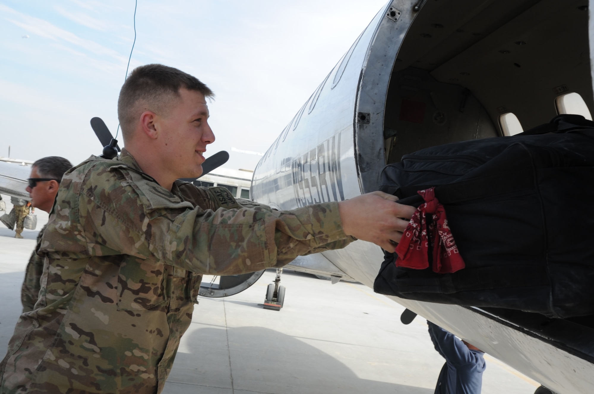 Airman 1st Class Andrew Jones, 455th Expeditionary Aerial Port Squadron air terminal operations controller, offloads luggage from a Short Takeoff and Landing flight on Bagram Airfield, Afghanistan, Jan. 29, 2013. The STOLS section of the 455th EAPS supports between 60 to 70 flights daily, carrying mail, cargo and passengers to various forward operating bases. (U.S. Air Force photo/Staff Sgt. David Dobrydney)