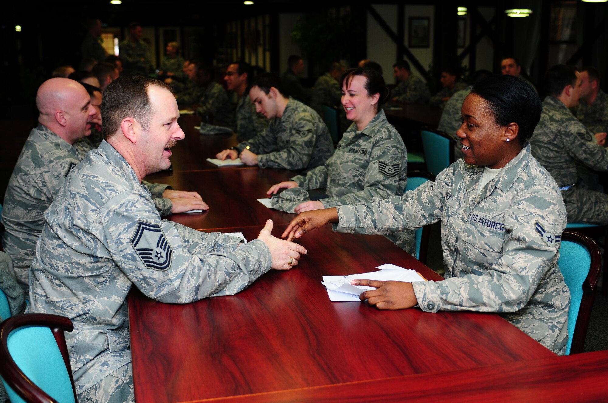 ROYAL AIR FORCE LAKENHEATH, England - Airman 1st Class Dejanae Acey, 48th Logistics Readiness Squadron vehicle operator, shakes hands with Senior Master Sgt. Shawn Petro, 48th Aerospace Medical Squadron superintendent, during the speed mentoring event Jan. 28, 2013. The Liberty Wing Top 3 sponsored the first ever 48th Fighter Wing speed mentoring event where Airman through technical sergeant spent five minutes with a Senior NCO to ask them before moving on to the next Senior NCO. (U.S. Air Force photo by Airman 1st Class Dana Butler)

