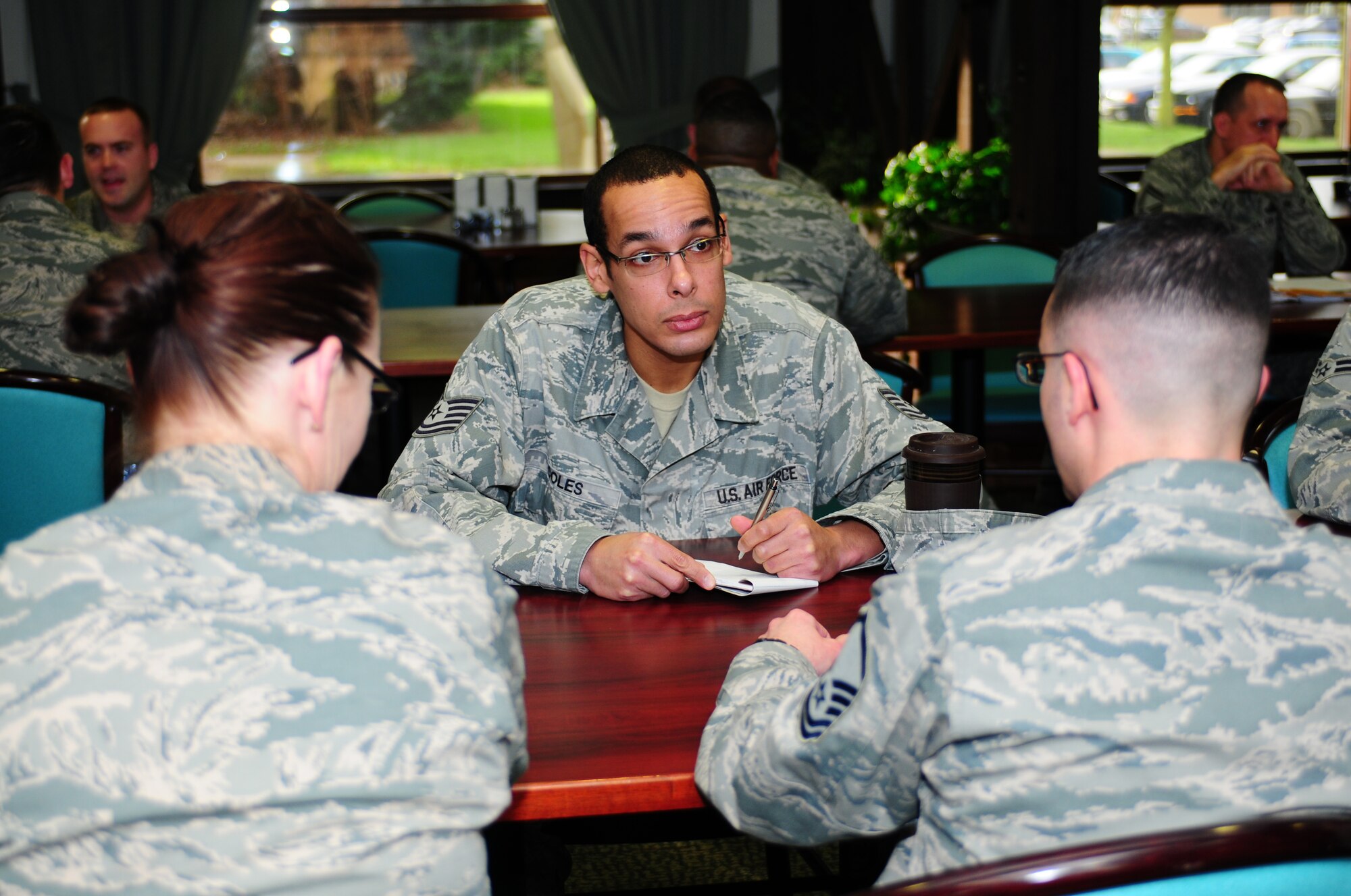 ROYAL AIR FORCE LAKENHEATH, England - Tech. Sgt. Coles, 48th Force Support Squadron manpower technician, takes notes during the speed mentoring event Jan. 28, 2013. The Liberty Wing Top 3 sponsored the first ever 48th Fighter Wing speed mentoring event where Airman through technical sergeant spent five minutes with a Senior NCO to ask them questions before moving on to the next Senior NCO. (U.S. Air Force photo by Airman 1st Class Dana Butler)

