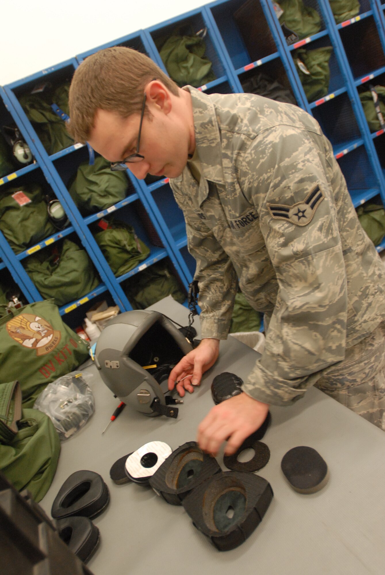 SOUTHWEST ASIA -- Airman 1st Class Brian Spears, shift supervisor, upgrades the communications headset inside of the HGU-55/P flyer's helmet for an upcoming mission. The 816th Expeditionary Airlift Squadron Aircrew Flight Equipment office maintains life-saving equipment for pilots and loadmasters on the C-17A Globemaster III at an undisclosed location Southwest Asia.(U.S. Air Force photo/Master Sgt. Christian Michael)