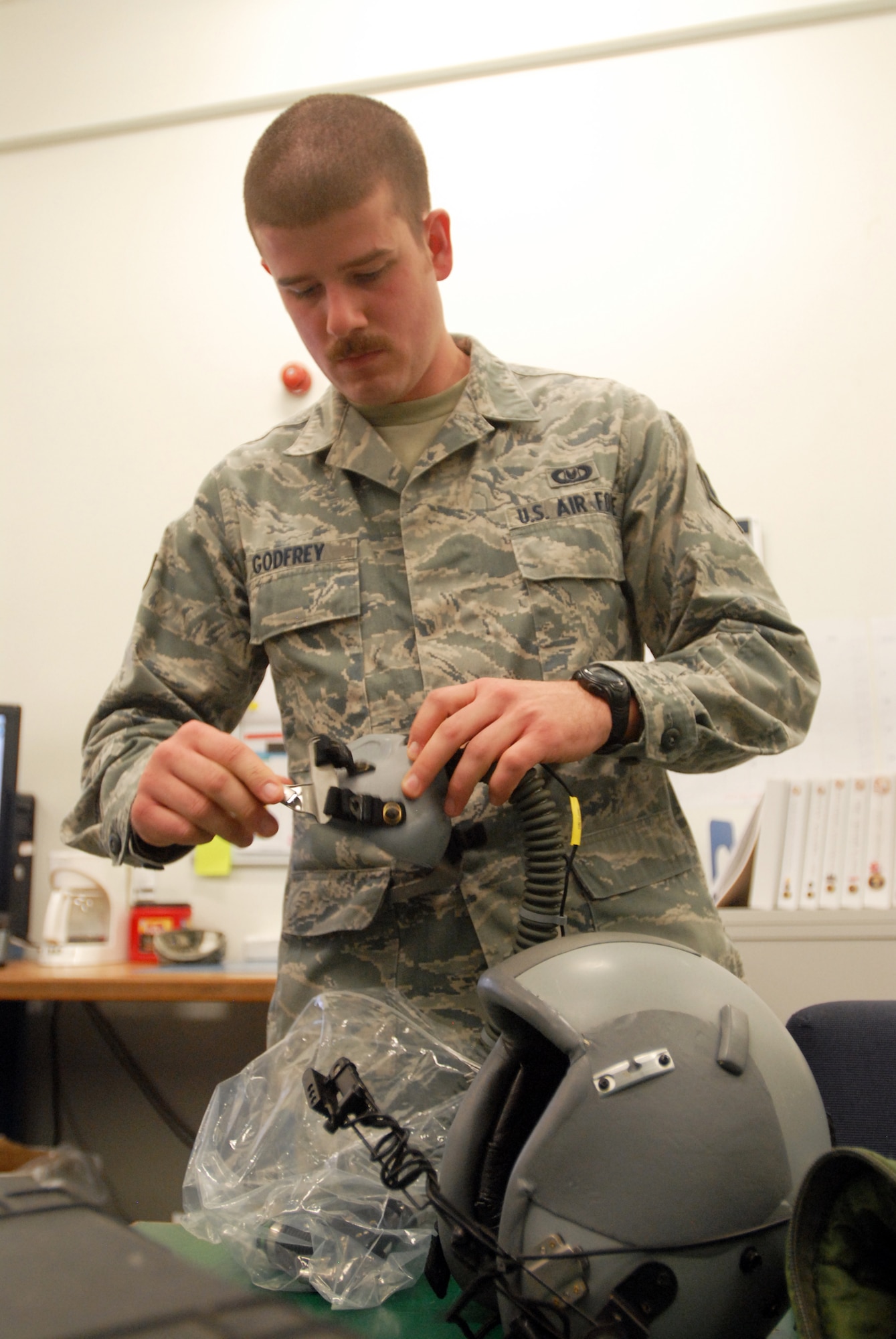 SOUTHWEST ASIA -- Senior Airman Daniel Godfrey, Aircrew Flight Equipment lead, performs an inspection on the HGU-55/P flyer's helmet commonly used by pilots. The 816th Expeditionary Airlift Squadron Aircrew Flight Equipment office maintains life-saving equipment for pilots and loadmasters on the C-17A Globemaster III at an undisclosed location Southwest Asia.(U.S. Air Force photo/Master Sgt. Christian Michael)