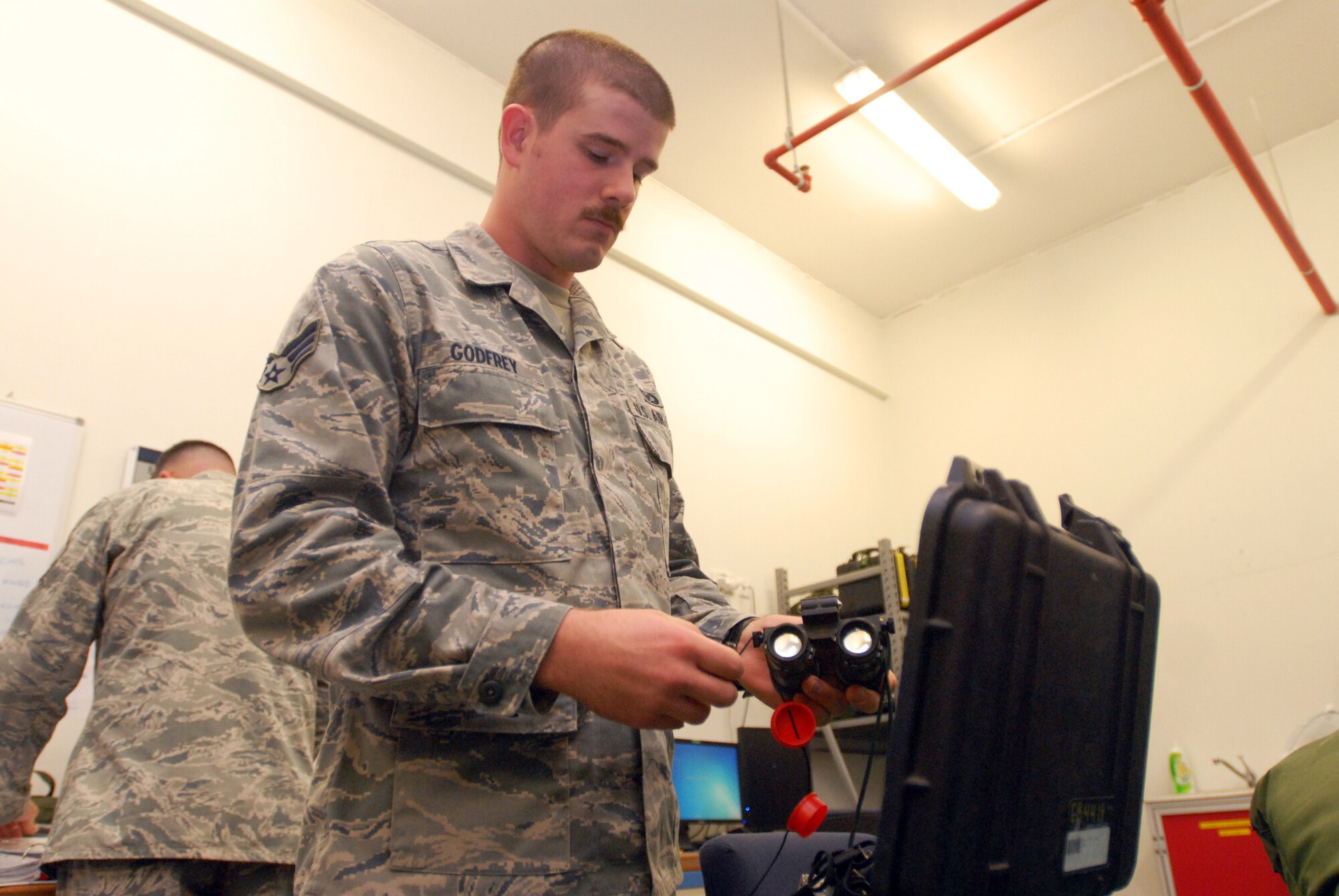 SOUTHWEST ASIA -- Senior Airman Daniel Godfrey, Aircrew Flight Equipment lead, performs an inspection on nightvision devices used for air operations. The 816th Expeditionary Airlift Squadron Aircrew Flight Equipment office maintains life-saving equipment for pilots and loadmasters on the C-17A Globemaster III at an undisclosed location Southwest Asia.(U.S. Air Force photo/Master Sgt. Christian Michael)
