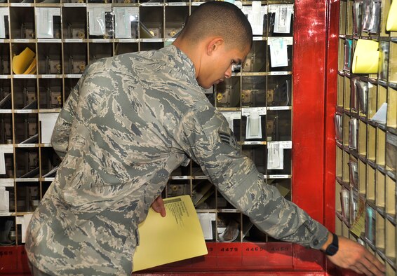 U.S. Air Force Senior Airman Marc Bates, 35th Communications Squadron postal clerk, places a package notification paper in a mailbox at Misawa Air Base, Japan, Jan. 24, 2013. Previously, the post office had yellow slips to inform you of a package, now they have a yellow paper that includes your name, the package tracking number, package arrival date and what shelf the package was stored. (U.S. Air Force photo by Airman 1st Class Zachary Kee)