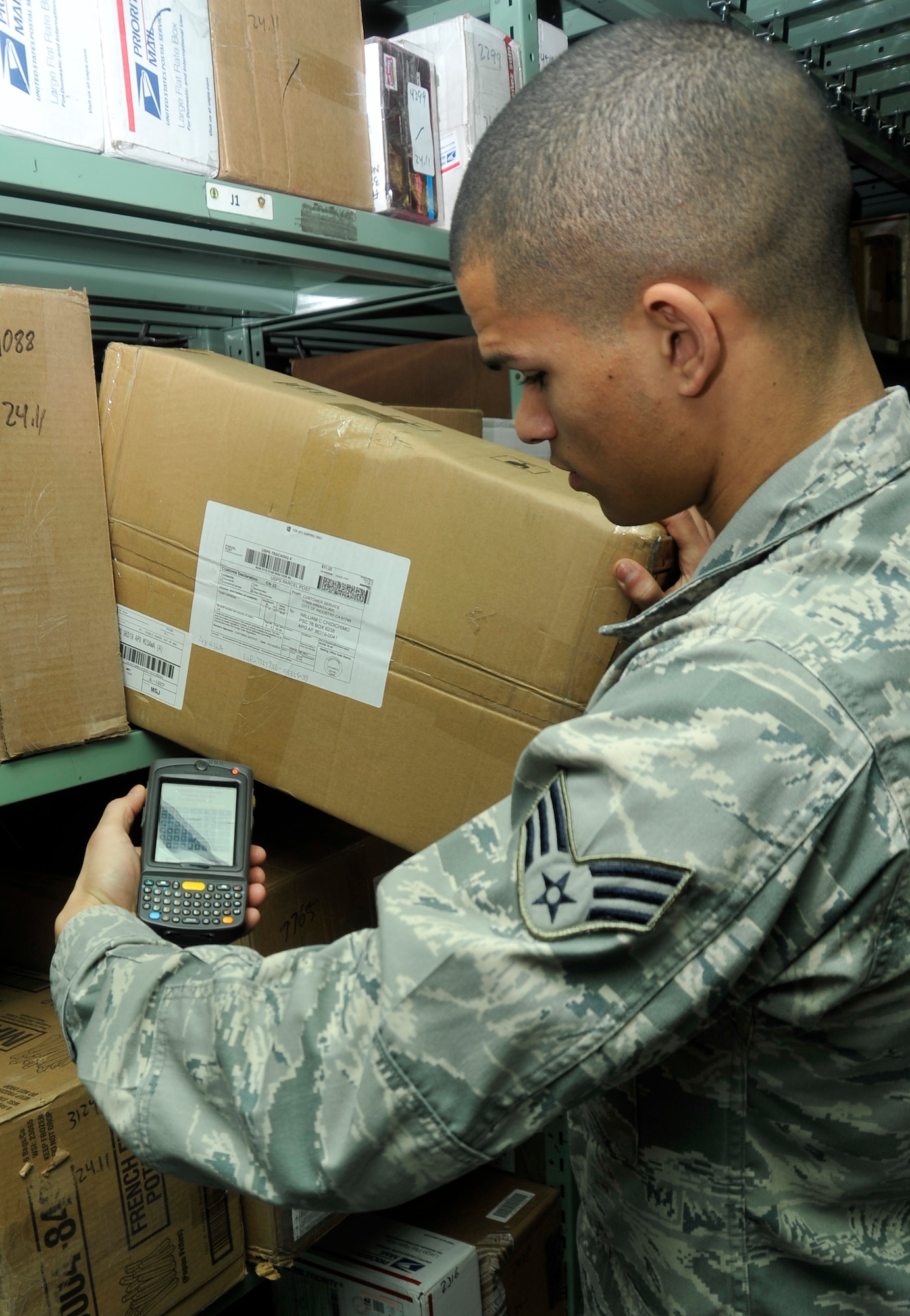U.S. Air Force Senior Airman Marc Bates, 35th Communications Squadron postal clerk, scans an incoming package at Misawa Air Base, Japan, Jan. 24, 2013. Before the Trackpad upgrade, the post office would write everything by hand into a book and the process took two people to accomplish. Now, it only takes one person to scan the package for proper documentation. (U.S. Air Force photo by Airman 1st Class Zachary Kee)