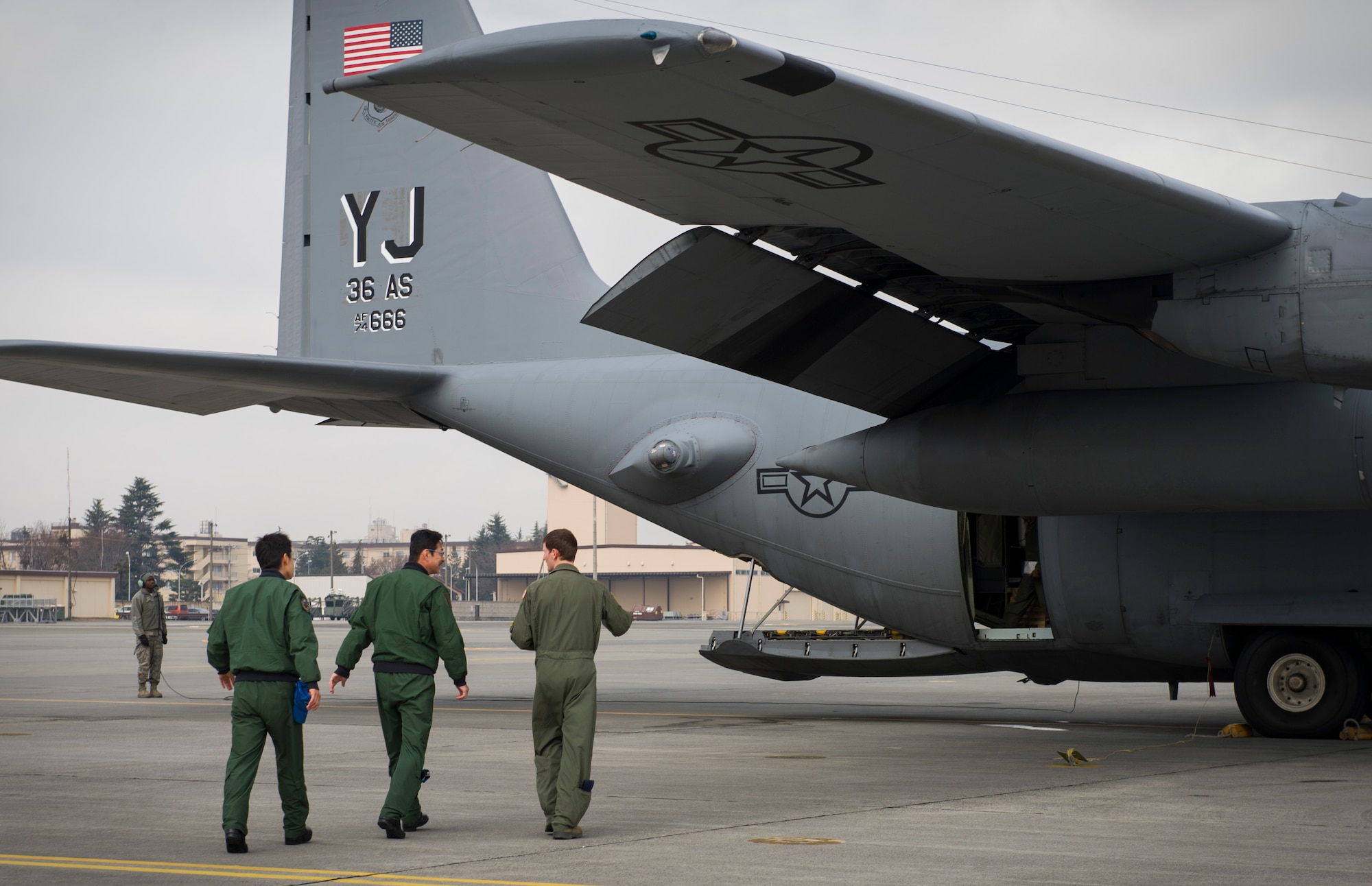 YOKOTA AIR BASE, Japan -- Loadmasters from Japan's Air Self Defense Force 401st Squadron watch as Tech. Sgt. Pablo Herrera, 36th Airlift Squadron loadmaster, goes over paperwork prior to loading pallets on a C-130 Hercules at Yokota Air Base, Japan, Jan. 9, 2013. In addition to sharing practices amongst aircrews, the JASDF aircrew also toured the Air Control Tower and learned about the airfield management flight and radar approach control missions at Yokota.  (U.S. Air Force photo by Senior Airman Andrea Salazar)