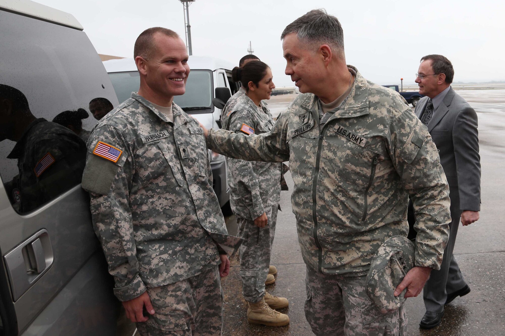 U.S. Army Lt. Gen. William N. Phillips greets U.S. Army Spc. Jason Harnasch, 10th Regional Support Group command group driver, during his visit to Kadena Air Base, Japan, Jan. 22, 2013. Phillips is the Principal Military Deputy, Assistant Secretary of the Army, Acquisition, Logistics and Technology Director, Acquisition Career Management. Phillips visited soldiers from the 1st Battalion 1st Air Defense Artillery Regiment here to view their equipment. (U.S. Air Force photo/Staff Sgt. Darnell T. Cannady)