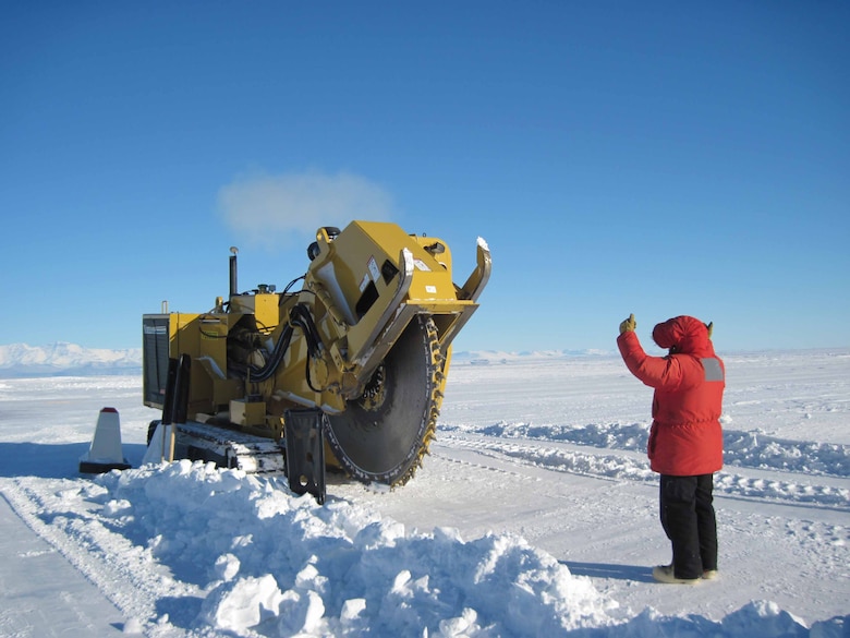 CRREL researchers prepare an area of the Pegasus White Ice Runway to install temperature probes at McMurdo Station, Antarctica.