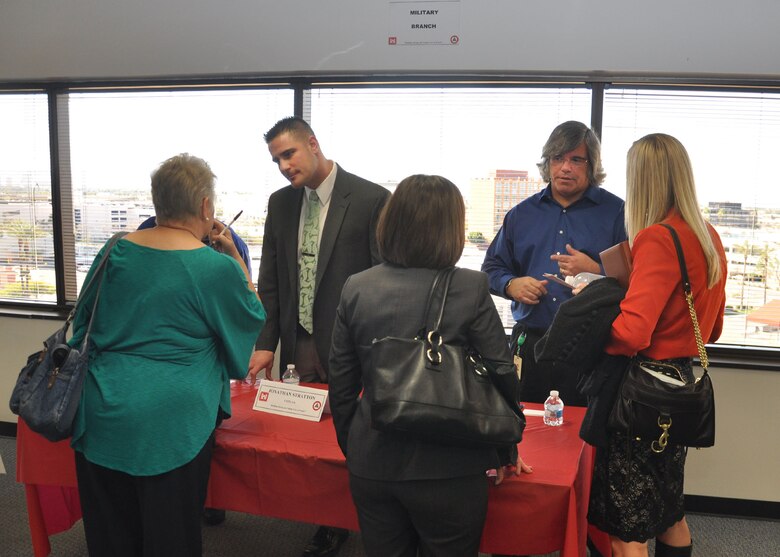 PHOENIX -Jonathan Stratton (left) and Joe Derungs, both with the U.S. Army Corps of Engineers Los Angeles District's Arizona/Nevada Area Office, speak with business representatives during the first Business Opportunities Open House held Jan. 29 at the District's downtown Phoenix office. Nearly 300 business owners and operators spoke with District representatives during the event designed to let business people learn about contract opportunities and gain insight on how to do business with the Corps.