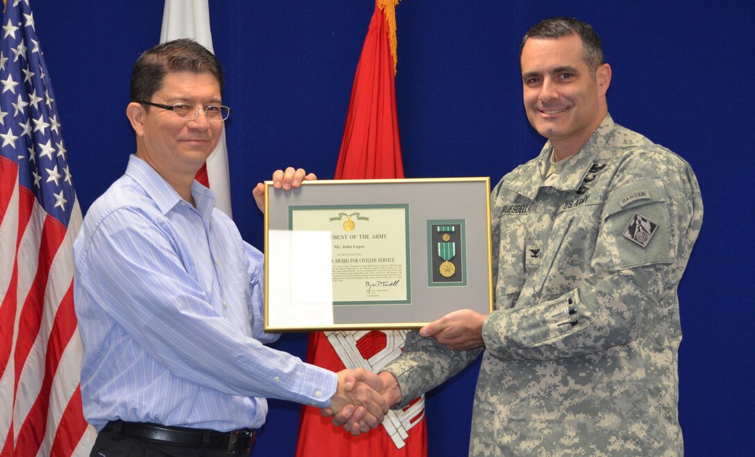 COL. Bryan P. Truesdell presents the Civilian Service Award to John Lopes, the Fire Protection Engineer in the Mechanical Section, Engineering and Construction Div., on his departure from the U.S. Corps of Engineers Japan District to Hawaii. 