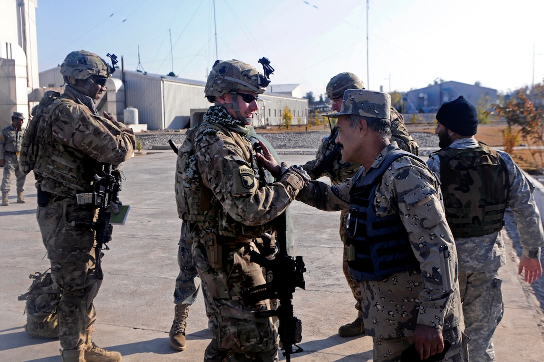 U.S. soldiers and Afghan border police shake hands on Combat Outpost Monti, Kunar province, Afghanistan, Jan. 21, 2013, after a successful mission to Observation Point 12 along the Afghanistan-Pakistan border.