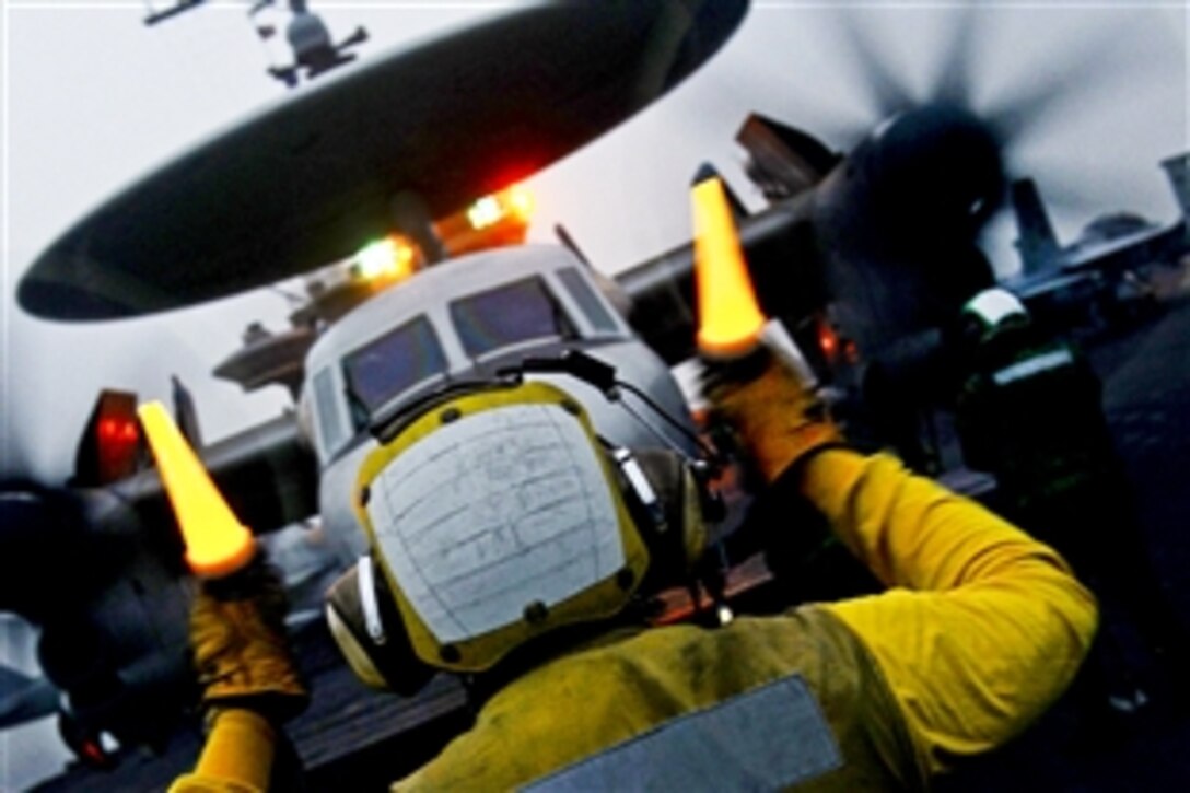 U.S. Navy Petty Officer 3rd Class Kevin Williams directs an E-2C Hawkeye on the flight deck of the aircraft carrier USS John C. Stennis in the 5th Fleet area of responsibility, Jan. 30, 2013. The Stennis is conducting maritime security operations, theater security cooperation efforts and support missions for Operation Enduring Freedom. The Hawkeye is assigned to Airborne Early Warning Squadron 112.
