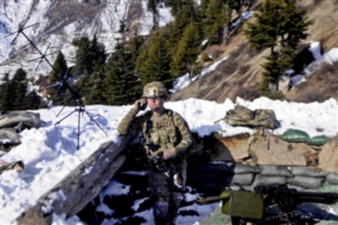 U.S. Army Spc. Paul Varn monitors the satellite communications radio at Observation Point 12 along the Afghanistan-Pakistan border in Kunar province, Afghanistan, Jan. 21, 2013. Varn, a communications specialist, is assigned to the 101st Airborne Division's 1st Brigade Combat Team.