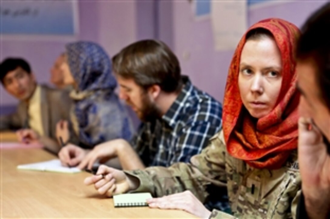 U.S. Army 1st Lt. Nicole Utley, right, listens to a conversation while taking notes during a meeting with the director of women's affairs in Farah City, Afghanistan, Jan. 29, 2013. Utley, a supply officer, is assigned to Provincial Reconstruction Team Farah.