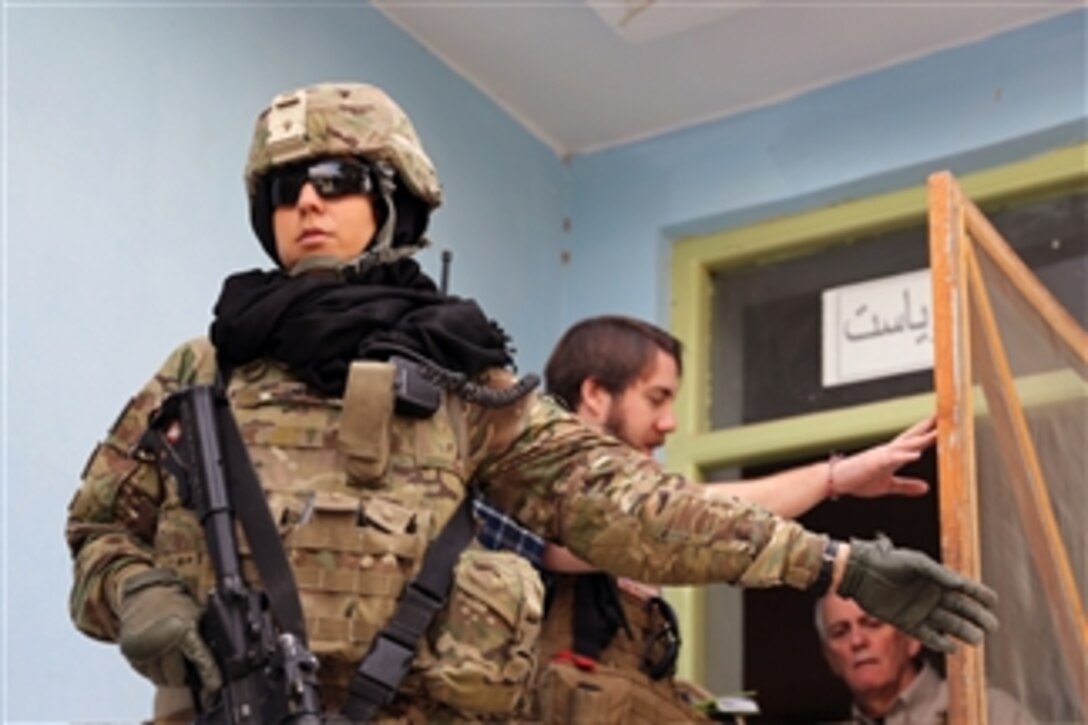 U.S. Navy Petty Officer 1st Class Megan Garcia provides security during a key leader engagement with the director of women's affairs in Farah city of the Farah province of Afghanistan on Jan. 29, 2013.  Farah Provincial Reconstruction Team members are attending the working group meeting on gender strategy with the director to discuss literacy program initiatives for women in the Bala Boluk and Pusht-e Rod districts.  Team Farah has the mission to train, advise and assist Afghan government leaders at the municipal, district and provincial levels in Farah province, Afghanistan.   The civil military team is comprised of members of the U.S. Navy, U.S. Army, the U.S. Department of State and the Agency for International Development.  