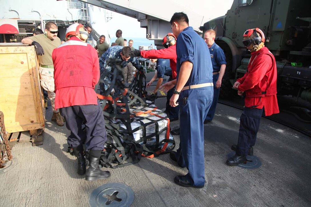Marines and sailors aboard the USS Rushmore conduct replenishment-at-sea, Jan. 21. The 15th Marine Expeditionary Unit is deployed as part of the Peleliu Amphibious Ready Group as a U.S. Central Command theater reserve force, providing support for maritime security operations and theater security cooperation efforts in the U.S. 5th Fleet area of responsibility. (U.S. Marine Corps photo by Cpl. Timothy R. Childers)