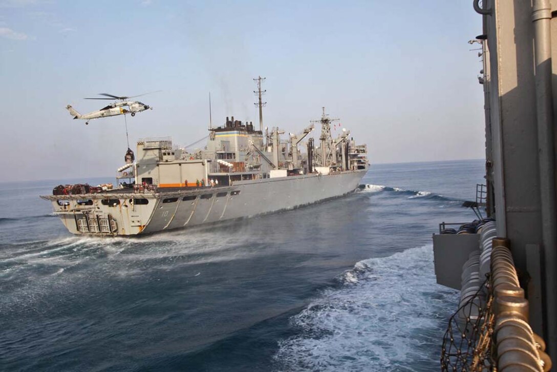 A MH-60S Knighthawk with Helicopter Combat Squadron 23 conducts a vertical replenishment from the USNS Bridge to the USS Rushmore during a replenishment-at-sea, Jan. 21. The 15th Marine Expeditionary Unit is deployed as part of the Peleliu Amphibious Ready Group as a U.S. Central Command theater reserve force, providing support for maritime security operations and theater security cooperation efforts in the U.S. 5th Fleet area of responsibility. (U.S. Marine Corps photo by Cpl. Timothy R. Childers)