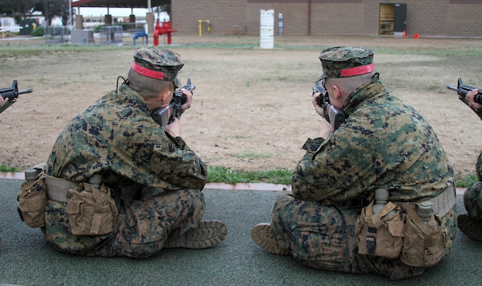 Recruits of Company C, 1st Recruit Training Battalion, sight in on a barrel during Grass Week aboard Edson Range, Marine Corps Base Camp Pendleton, Calif., Jan. 24.