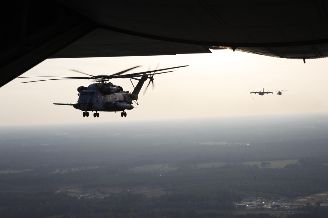In the distance, a VMGR-252 KC-130J refuels a HMH-366 CH-53E Super Stallion during long-range raid training near Wilmington Jan. 24. The squadrons train in realistic scenarios and coordinate with sister units to help meet mission objectives and keep planning skills sharp.
