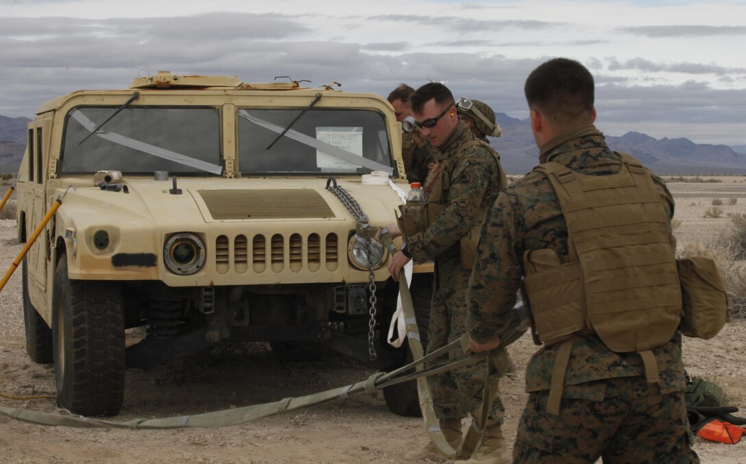 Marines with Helicopter Support Team, 3rd Marine Aircraft Wing, prepare a humvee to be lifted externally by a CH-53E Super Stallion aboard Creech Air Force Base, Nev., Jan. 25. The straps are used to connect the humvee to hooks hanging below the aircraft, and can safely carry approximately 25,000 pounds. 