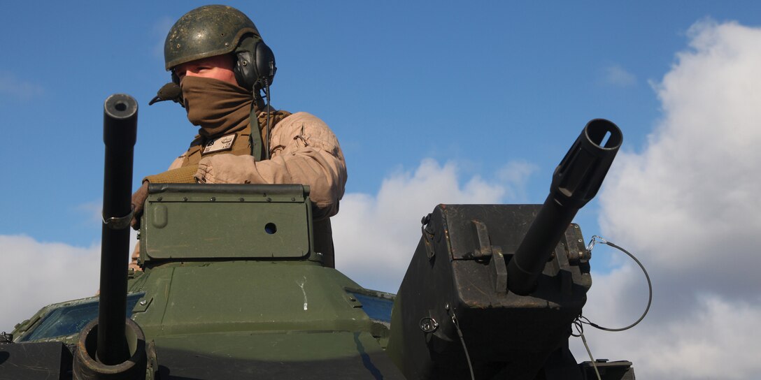 Cpl. Christopher M. Ault provides rear security during an assault amphibious vehicle patrol Jan. 24 in the North Fuji Maneuver Area at Combined Arms Training Center Camp Fuji on mainland Japan. During the patrol, Ault instructed Marines with 12th Marine Regiment on AAV capabilities and operations. Ault is an AAV crew chief with Combat Assault Battalion. Both units are part of 3rd Marine Division. 