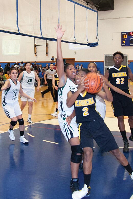 Jasmine Rhodes, No. 2 of the Kadena Panthers, aggressively fends off a defender Jan. 27 during the championship game against the Kubasaki Dragons in the Okinawan-American Friendship Basketball Tournament 2013 at Risner Gym on Kadena Air Base. The Kadena High School girls and boys teams both won first place in the tournament. 