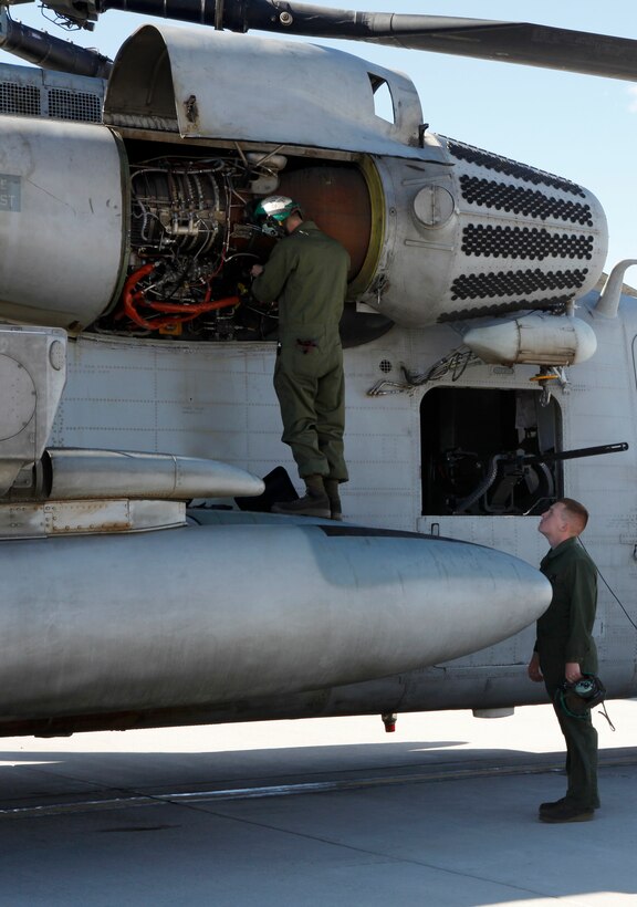 Maintenance Marines with Marine Heavy Helicopter Squadron 466, 3rd Marine Aircraft Wing, check over an engine that was fixed before a flight aboard Creech Air Force Base, Nev., Jan. 26. Before each flight, many Marines look at the aircraft to ensure it is safe to fly. 
