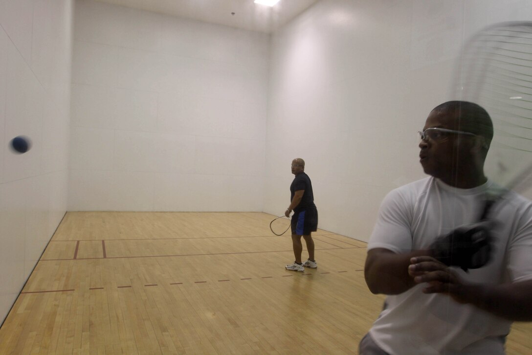 Maj. Robert Guice, the director for Marine Air Command and Control Squadron Experimental, prepares to return a serve from Staff Sgt. Nelson Leandry, the Company Gunnery Sergeant for Combat Logistics Regiment 17, during a racquetball tournament at Paige Field House here Jan. 30. Guice earned first place in this Commanding General's Cup event.