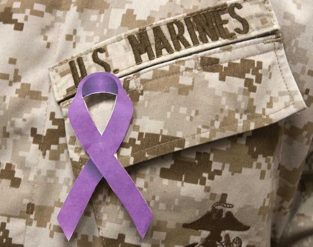 A Marine wears a purple ribbon representing support to stop domestic violence at the Marine Corps Air Station Miramar Marine and Family Services Counseling Center aboard MCAS Miramar, Calif., Oct. 18. One of the priorities of the Committed and Engaged Leadership Campaign is lowering the number of Domestic Violence cases in the Marine Corps. 