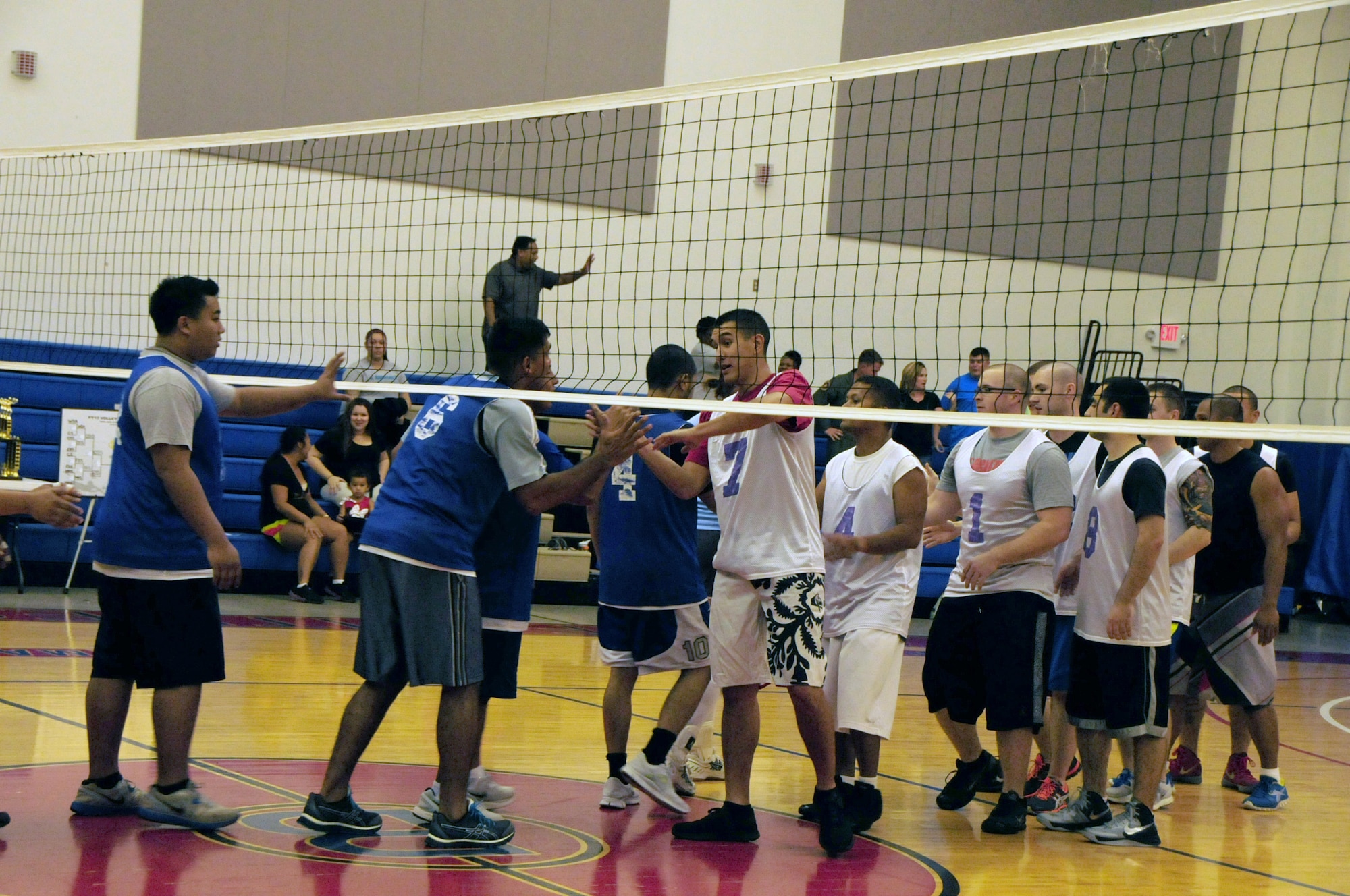 The 36th Operation Support Squadron and 36th Force Support Squadron volleyball team members shake hands at the end of the intramural volleyball championship game at Andersen Air Force Base, Guam, Jan. 28, 2013. The 36th OSS emerged victorious against the 36th FSS in the final game of this season to claim the title of base champions. (U.S. Air Force photo/Airman 1st Class Marianique Santos/Released)