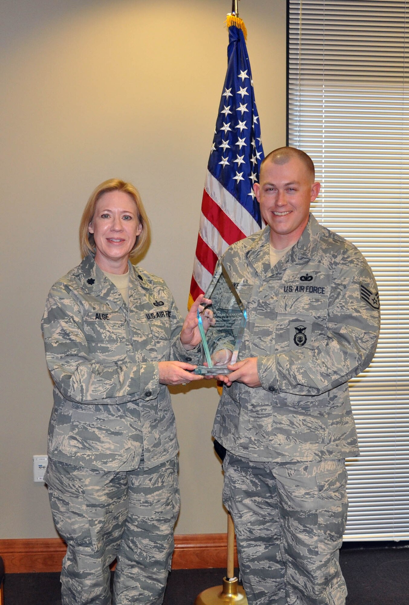 (Right) Staff Sgt. Zachary Enke, 926th Security Forces Flight assistant squad leader, receives Air Force Reserve Command's 2012 Outstanding Security Forces Noncommissioned Officer Support Staff award from Lt. Col. Connie Alge, 926th Force Support Squadron commander, here Jan. 31. Enke was recognized for instructing 50 short-notice deployers to meet Overseas Contingency Operations taskings, as well as creating a munitions tracking system for the Regular Air Force that cut man hours by 35 percent. Additionally, Enke coordinated more than 2,500 weapons inspections for 15 squadrons that maintained 100 percent mission readiness, among many other accomplishments. (U.S. Air Force photo/Maj, Jessica Martin)