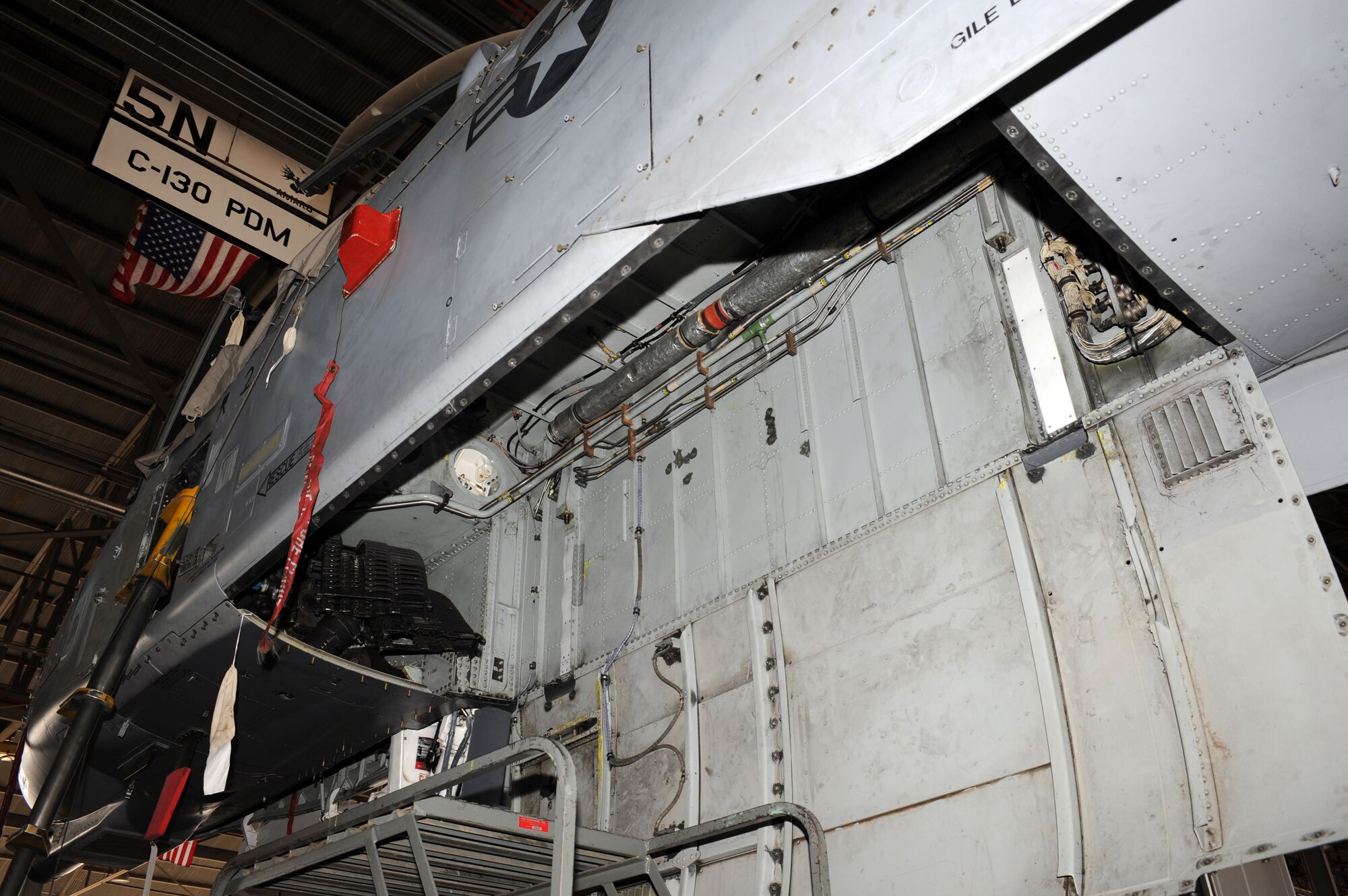 The gun bay of an A-10A Thunderbolt is open under a maintenance hangar on Davis-Monthan Air Force Base, Ariz., Jan. 24, 2013. Once the A-10, tail number 174, is converted into a storm chaser the former gun bay will house computer equipment used to track storms. (U.S. Air Force photo by Senior Airman Timothy Moore/Released)