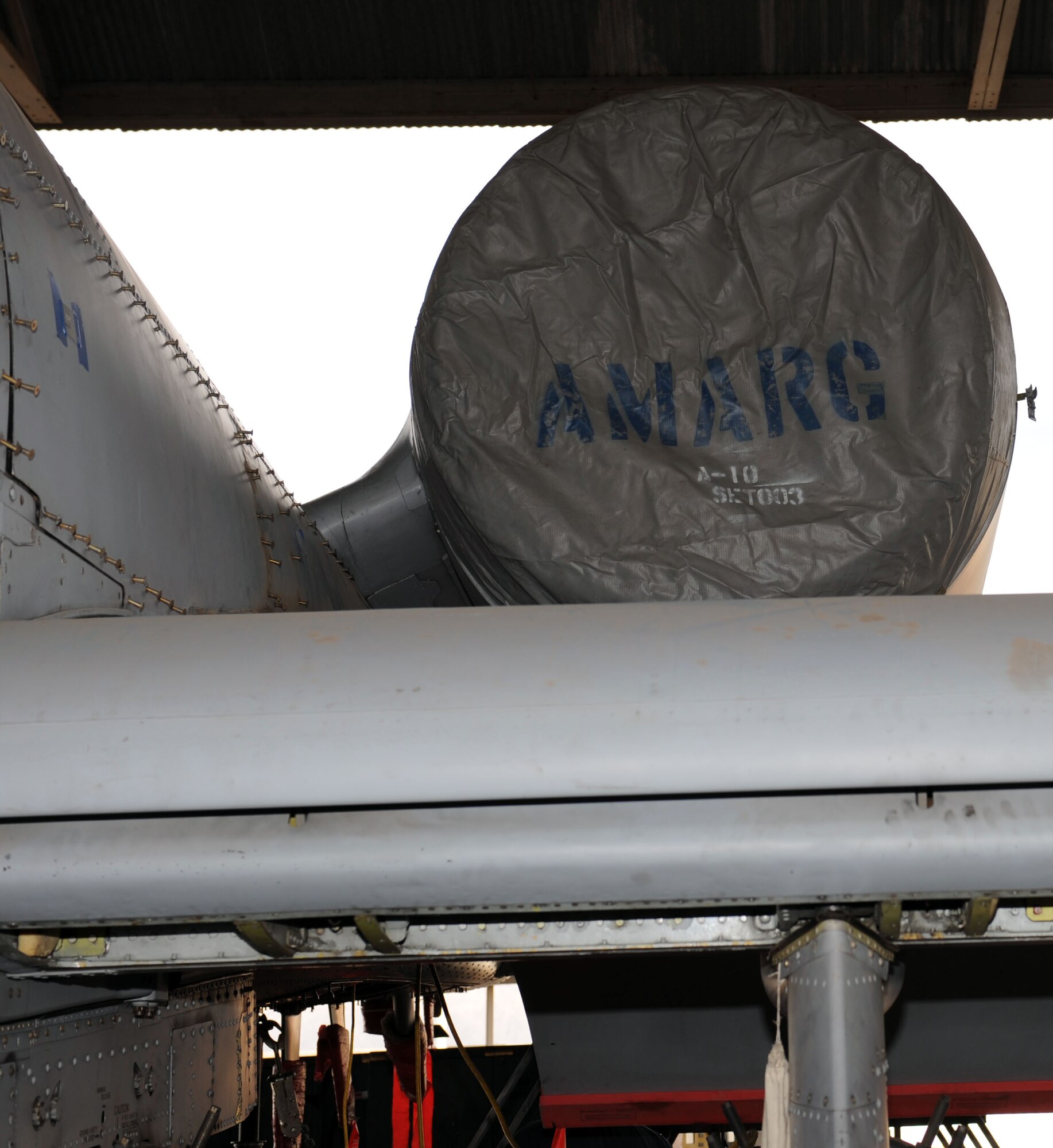 Kenneth Thompson, 576th Aerospace Maintenance and Regeneration Squadron aircraft mechanic, aligns a portion of the pre-cooler ram air duct onto the top of an A-10A Thunderbolt on Davis-Monthan Air Force Base, Ariz., Jan. 23, 2013. The 309th Aerospace Maintenance and Regeneration Group is regenerating the aircraft, which was used as a trainer for munitions load crews, so that it can be converted into a storm chaser. (U.S. Air Force photo by Senior Airman Timothy Moore/Released)