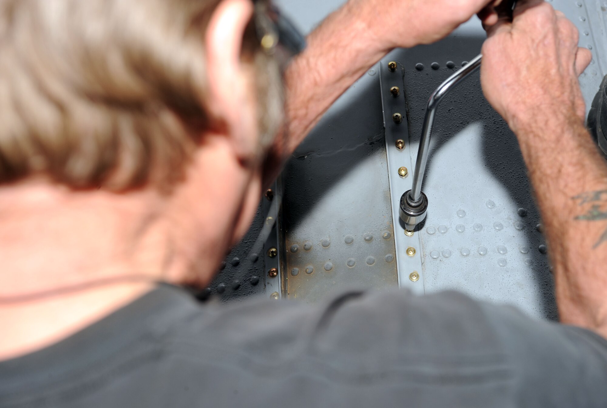 Kenneth Thompson, 576th Aerospace Maintenance and Regeneration Squadron aircraft mechanic, fastens a screw on top of an A-10A Thunderbolt on Davis-Monthan Air Force Base, Ariz., Jan. 23, 2013. After the 309th Aerospace Maintenance and Regeneration Group is done repairing the aircraft, it will take approximately one year to convert the aircraft into a drone used to collect data on storms. (U.S. Air Force photo by Senior Airman Timothy Moore/Released)