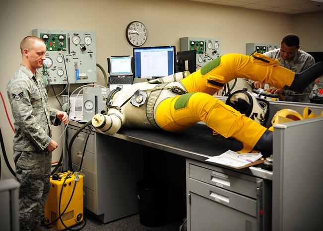Senior Airman Joshua Fike (left) and Louis Iverson, 9th Physiological Support Squadron suit maintenance technicians, run a pressure sensor test on a full pressure suit at Beale Air Force, Calif., Jan. 24, 2013. The suits, which are used by U-2 Dragon Lady pilots, receive a full maintenance inspection every 90 to 120 days or as needed. Each test takes up to three hours to ensure pilot safety in case of depressurization at high altitude. (U.S. Air Force photo by Senior Airman Shawn Nickel/Released)