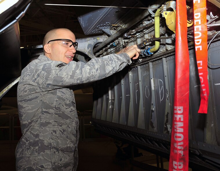 Airman 1st Class Chris Yetter, 22nd Maintenance Squadron crew chief, changes a hydraulic line clamp on a KC-135 Stratotanker during periodic inspection Jan. 31, 2013, McConnell Air Force Base, Kan. Stratotankers are routinely scheduled for 10 days in the inspection dock; a three day inspection period and seven days for fixing any problems that might have been found. (U.S. Air Force photo/Senior Airman Laura L. Valentine)