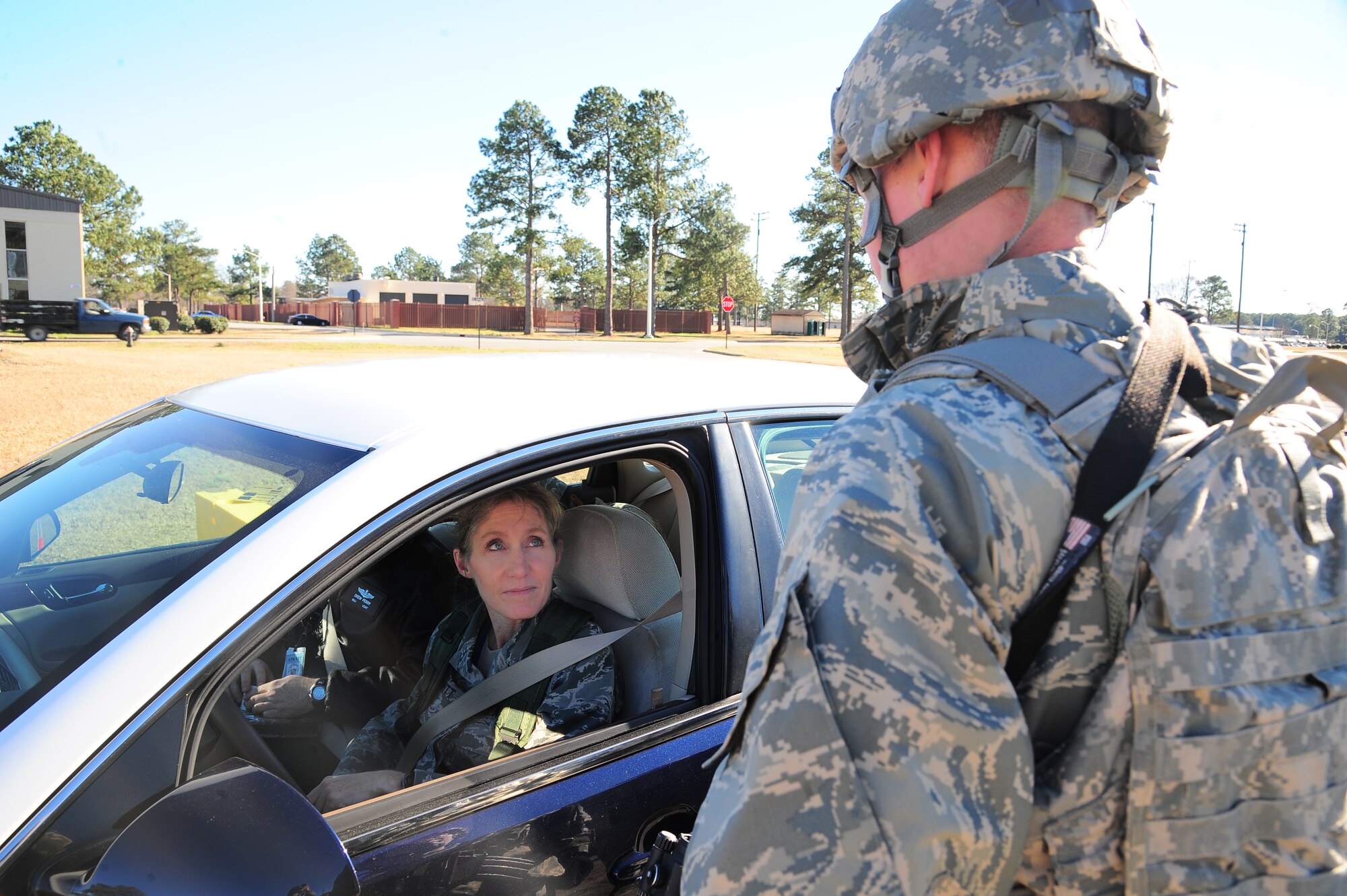 U.S. Air Force Airman Dylan Powell, 4th Security Forces patrolman, asks Col. Jeannie Leavitt, 4th Fighter Wing commander, for identification prior to entering the base during Operational Readiness Exercise Coronet Warrior 13-01B, at a simulated deployed location on Seymour Johnson Air Force Base, N.C., Jan. 31, 2013. Leavitt visited Base X during the ORE in order to get a better feel for how the 4th FW mission was being carried out. (U.S. Air Force photo/Airman 1st Class Aubrey White/Released)