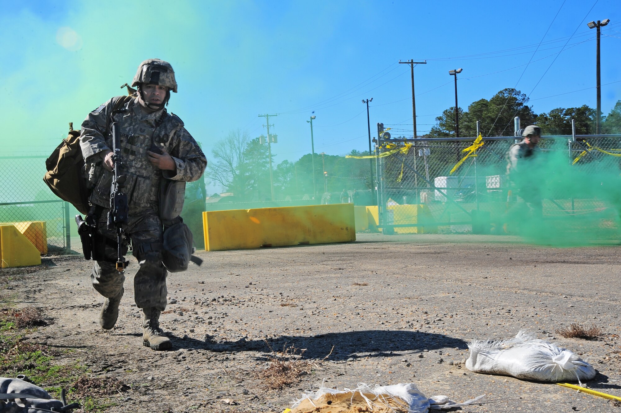U.S. Air Force Tech. Sgt. Michael Maldonado, 4th Security Forces Squadron Operational Readiness Inspection preparation team leader, runs to provide back-up during a car-bombing and small arms fire scenario, at a simulated deployed location on Seymour Johnson Air Force Base, N.C., Jan. 31, 2013. Several of Maldonado's teammates were simulated wounded or killed during the attack, causing a need for back up forces to defend the base's main entry control point. (U.S. Air Force photo/Airman 1st Class Aubrey White/Released)