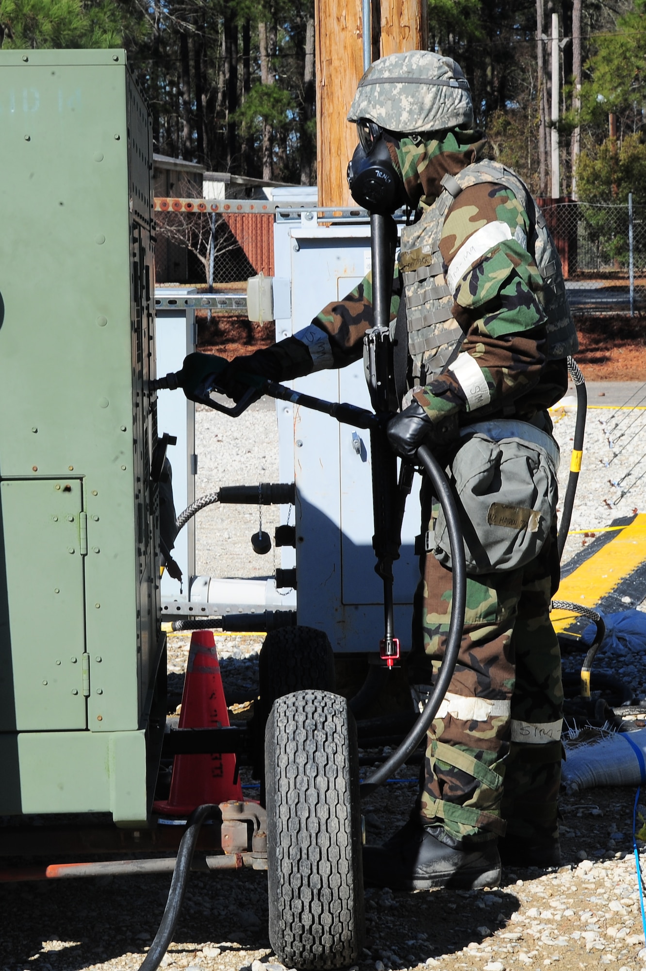 U.S. Air Force Airman 1st Class Hayden Park, 4th Civil Engineer Squadron power production technician, refuels a generator during Operational Readiness Exercise Coronet Warrior 13-01B, at a simulated deployed location on Seymour Johnson Air Force Base, N.C., Jan. 31, 2013. Generators located throughout Base X are used as back-up power sources during the ORE. (U.S. Air Force photo/Airman 1st Class Aubrey White/Released)