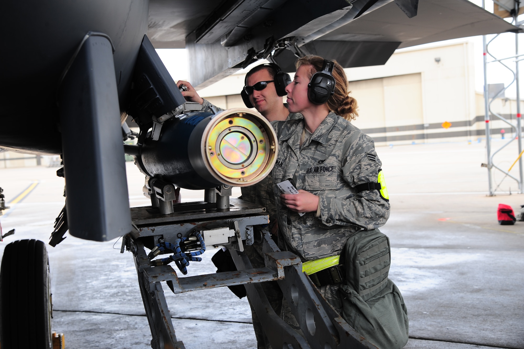 U.S. Air Force Staff Sgt. Andrew Hogan and Senior Airman Kaitlyn Cushman, 4th Aircraft Maintenance Squadron weapons load crew members, download a GBU-12 training bomb from an F-15E Strike Eagle during Operational Readiness Exercise Coronet Warrior 13-01B, at a simulated deployed location on Seymour Johnson Air Force Base, N.C., Jan. 30, 2013. Strike Eagle aircrew simulated use of the air to ground attack bomb during the ORE. (U.S. Air Force photo/Airman 1st Class Aubrey White/Released)