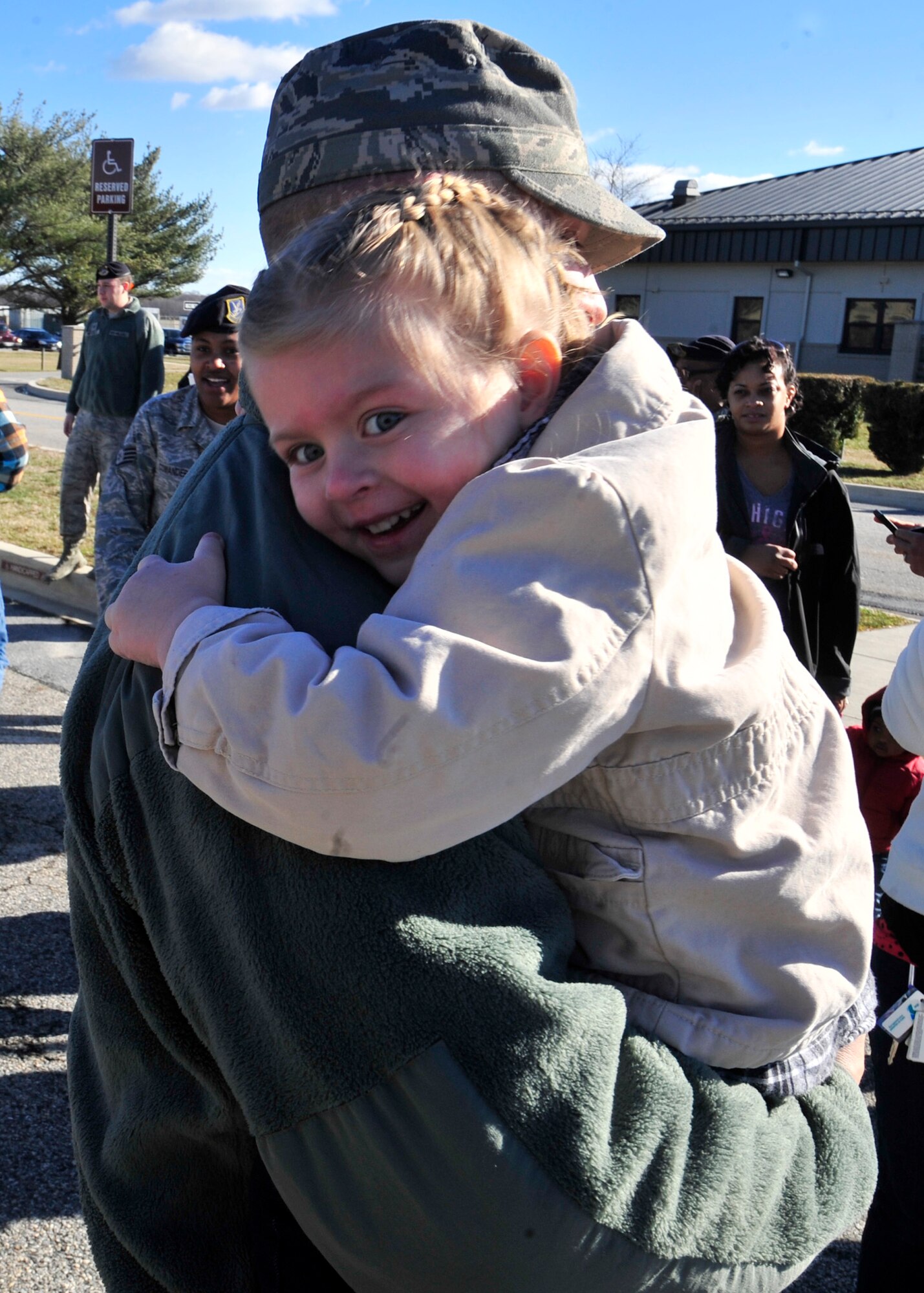 Peyton Holub hugs her father Staff Sgt. Jeffrey Holub, 436th Security Forces Squadron, after her dad’s return from deployment Jan. 31, 2013, at the 436th SFS building on Dover Air Force Base, Del. Holub and two teams of 436th SFS members returned from a six-month deployment to Southwest Asia. (U.S. Air Force photo by Tech. Sgt. Chuck Walker)