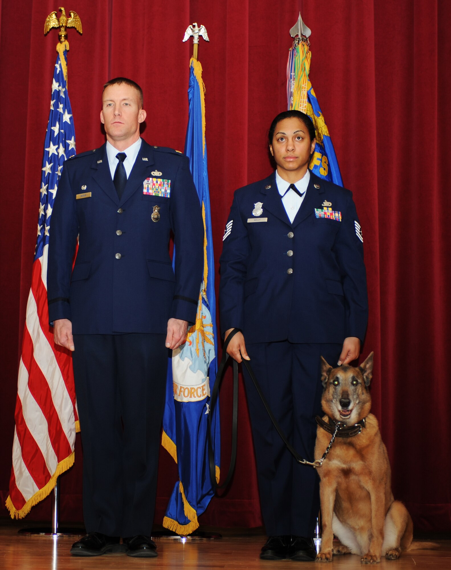U.S. Air Force Maj. Ryan Bodge, 366th Security Forces Squadron commander, stands with Tech. Sgt. Roaseann Kelly, 366th SFS assistant flight chief, and retired military working dog Tanja during the canine’s retirement ceremony Jan. 31, 2013, at Mountain Home Air Force Base, Idaho. Tanja served as a detection and patrol dog and has deployed from MHAFB five times. After working with six different Defender handlers, she has found a home with her last handler, Sergeant Kelly. (U.S. Air Force photo by Senior Airman Benjamin Sutton)