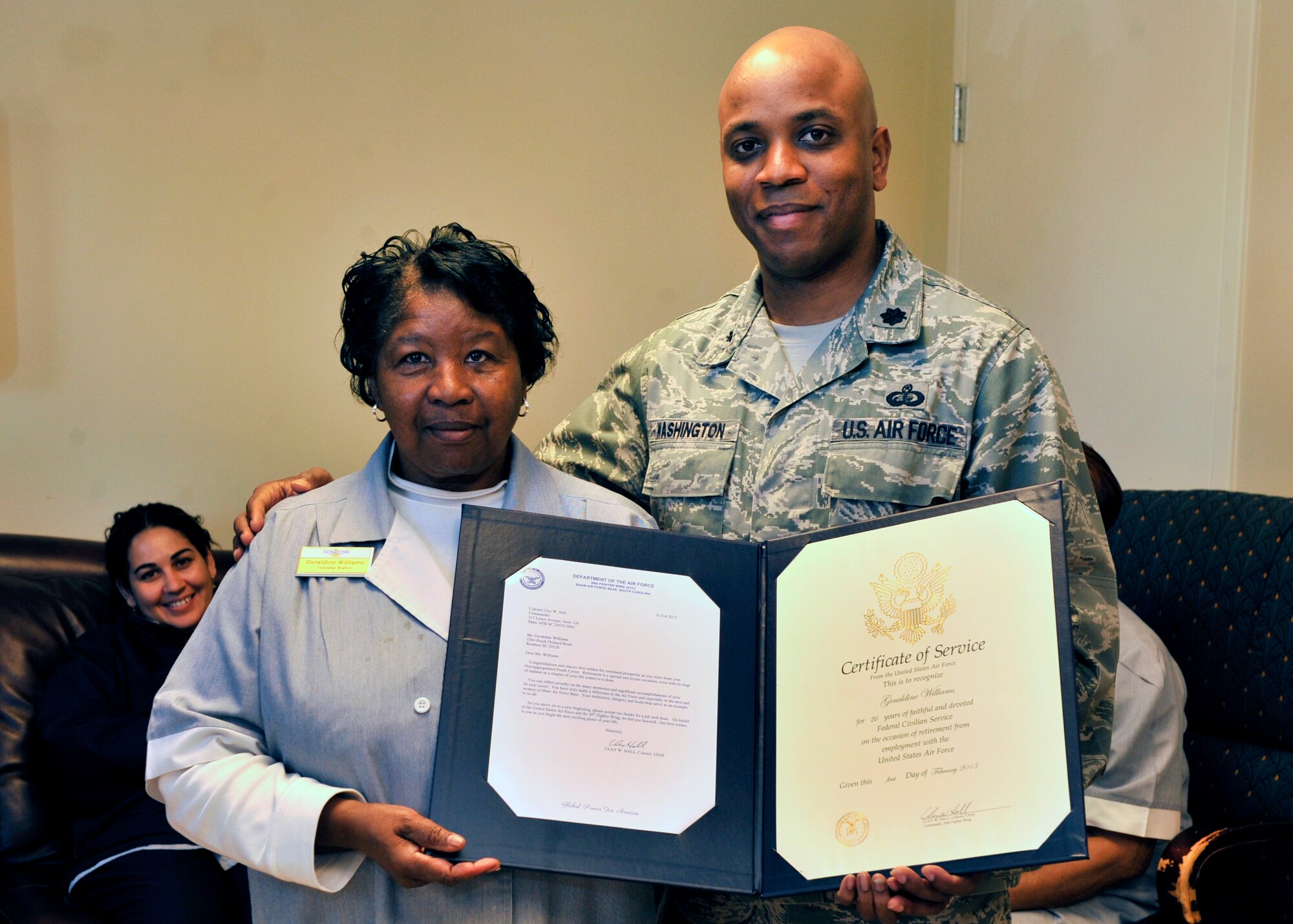 U.S. Air Force Lt. Col. Dalian Washington, 20th Force Support Squadron commander, presents Geraldine Williams, 20th Force Support Squadron Carolina Pines house keeper, with a certificate of service during her retirement ceremony, Shaw Air Force Base, S.C., Jan. 31, 2013. Williams worked at Shaw for more than 31 years; 26 of those years were spent at the Carolina Pines Inn. (U.S. Air Force photo by Senior Airman Amber E. N. Jacobs/ Released)


