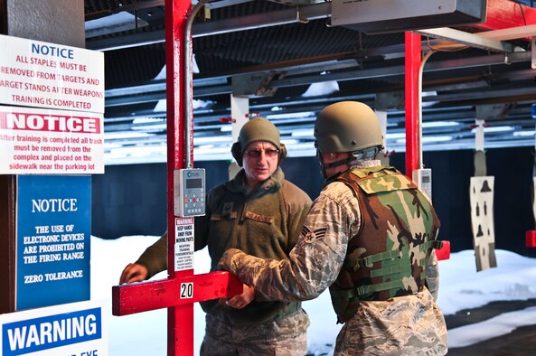 Master Sgt. Anthony Foor, 911th Airlift Wing Security Forces Squadron combat arms training and maintenance instructor, coaches an Airman, attached to the 911 AW Civil Engineer Squadron, on basic marksmanship fundamentals for the M16 qualification course, held at the firing range in Clinton, Pa.  The indoor firing range is used to service military members of the 911 AW, but is also utilized by numerous local and state law enforcement agencies and other military branches. These agencies train their personnel on a variety of small arms qualification courses. (U.S. Air Force photo by Tech. Sgt. Ralph Van Houtem/ Released)